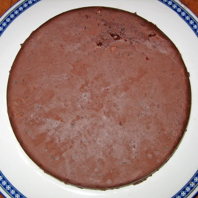 a brown chocolate cake on a white plate