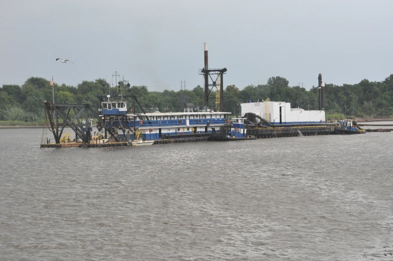 a ship traveling down the river with water behind it