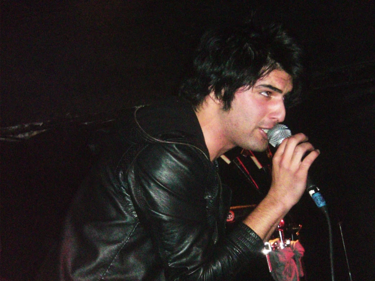 a young man singing into a microphone