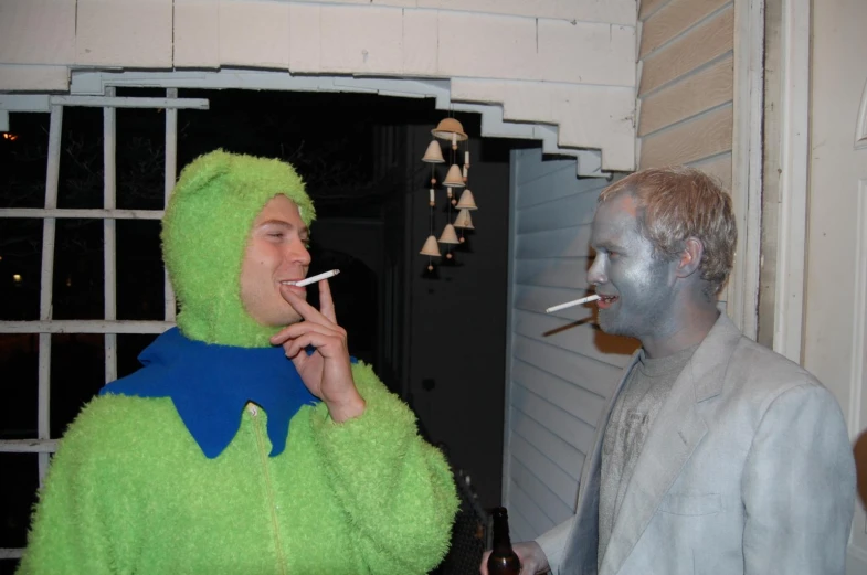 a couple of guys in costumes are smoking