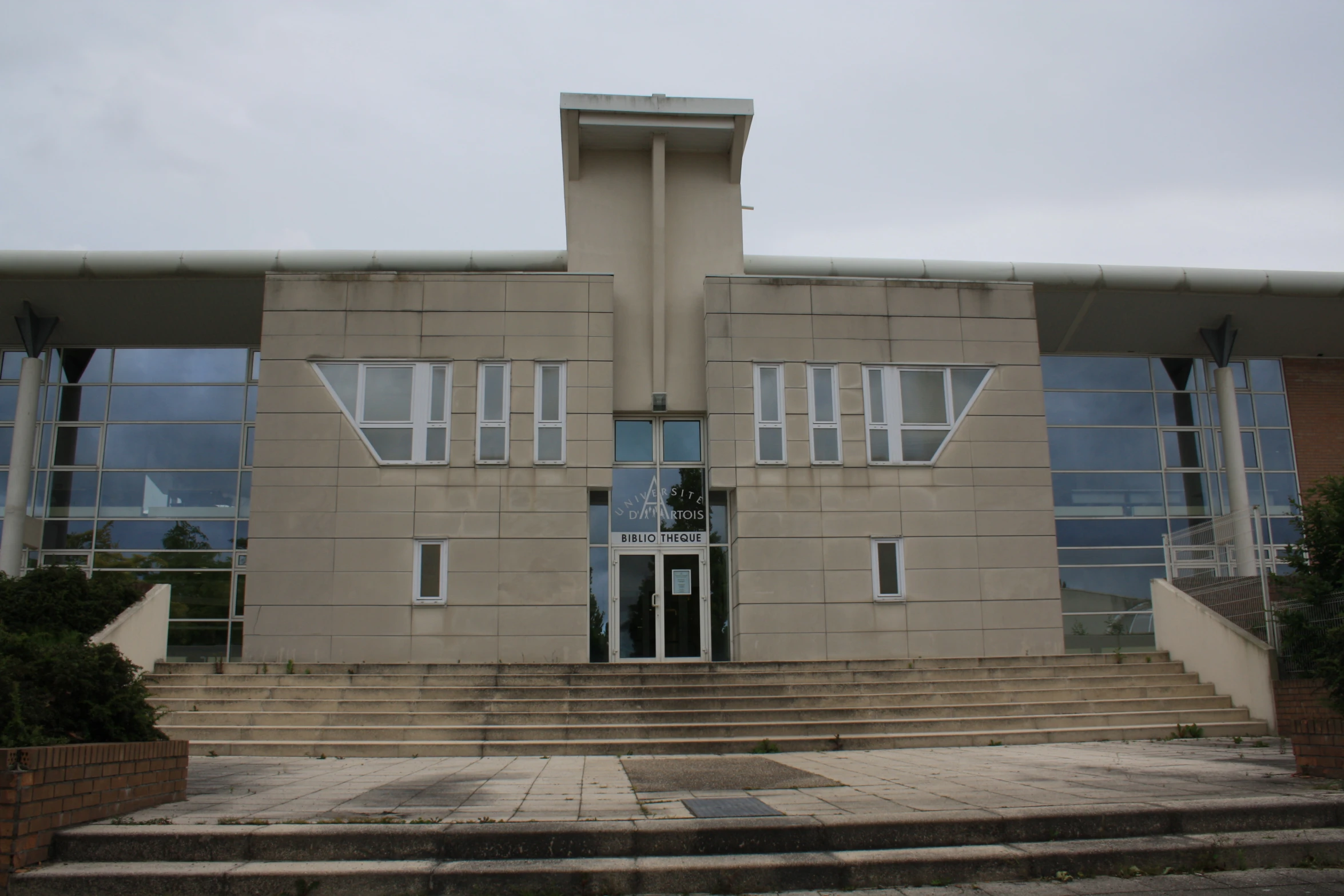 a modern building with stairs to the front and side of the building