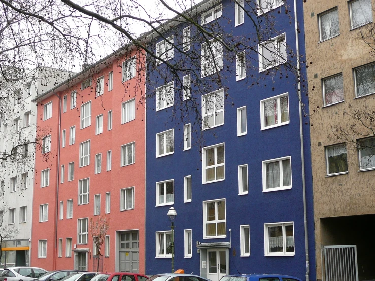 two very colorful buildings with parking spaces in between them