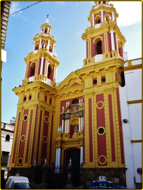 two very tall brown and yellow church steeples