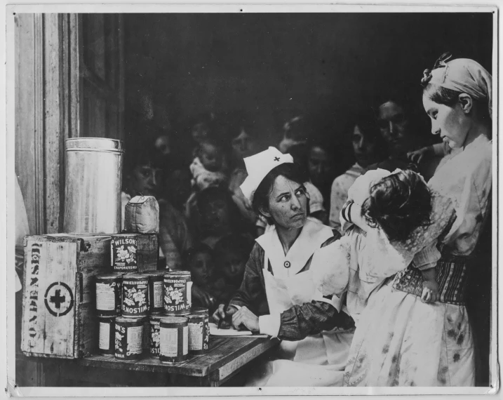 three people at a table with many jars