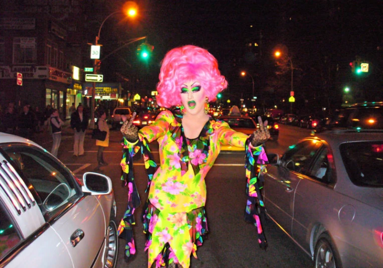 a woman in an odd - designed wig stands on the street