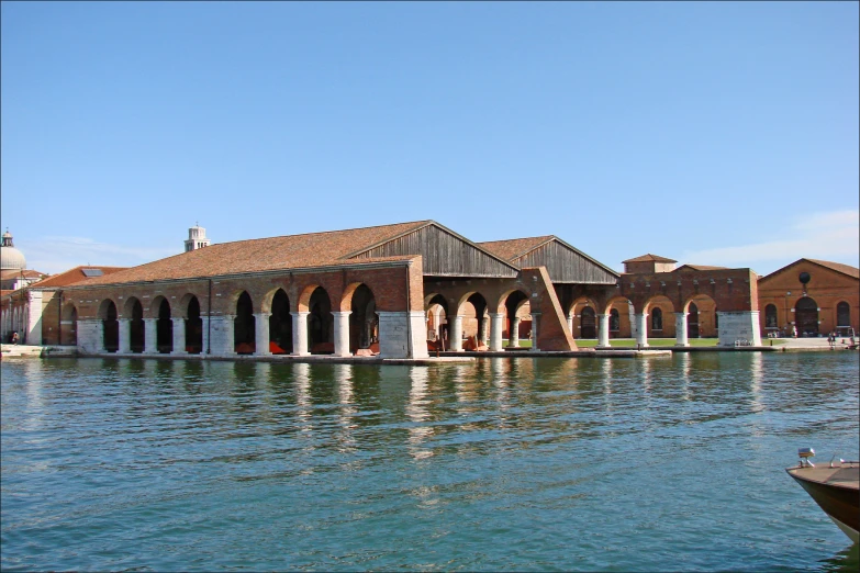 a building sits next to the lake that appears like it is almost submerged