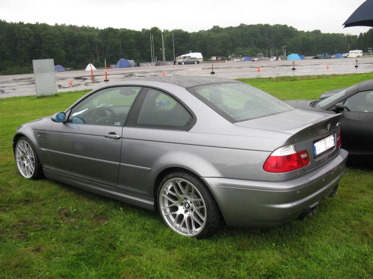 two cars parked side by side on grass