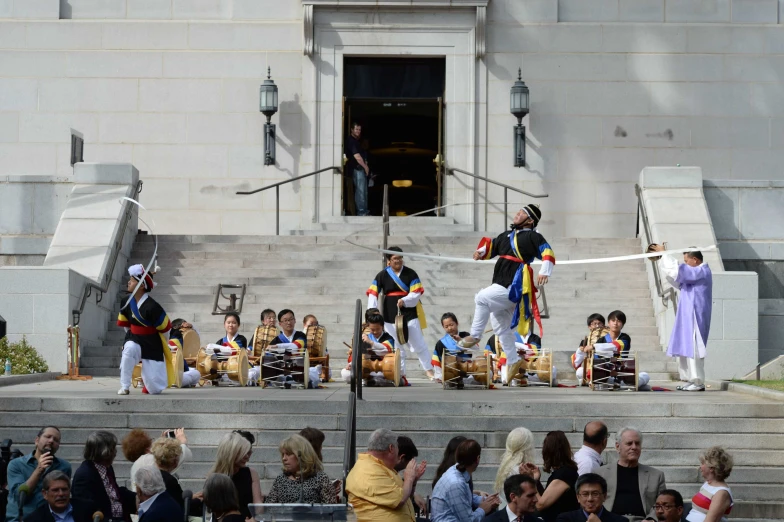 there is people standing on the steps with flags