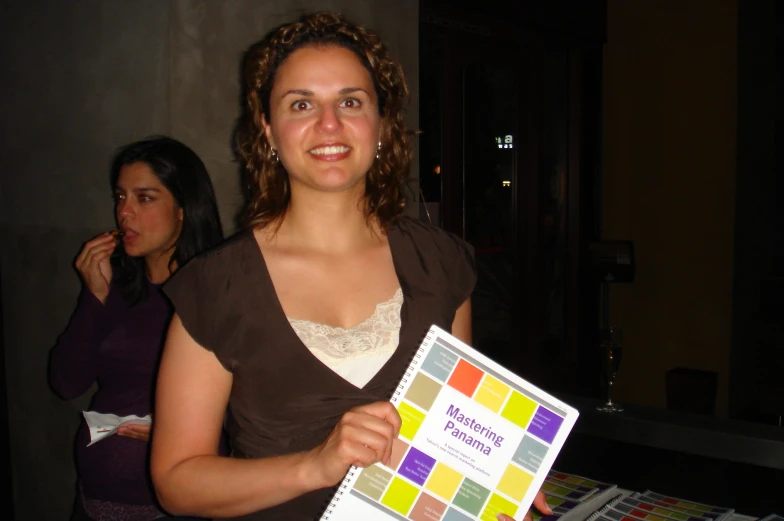 a lady holding up a multicolor swatter