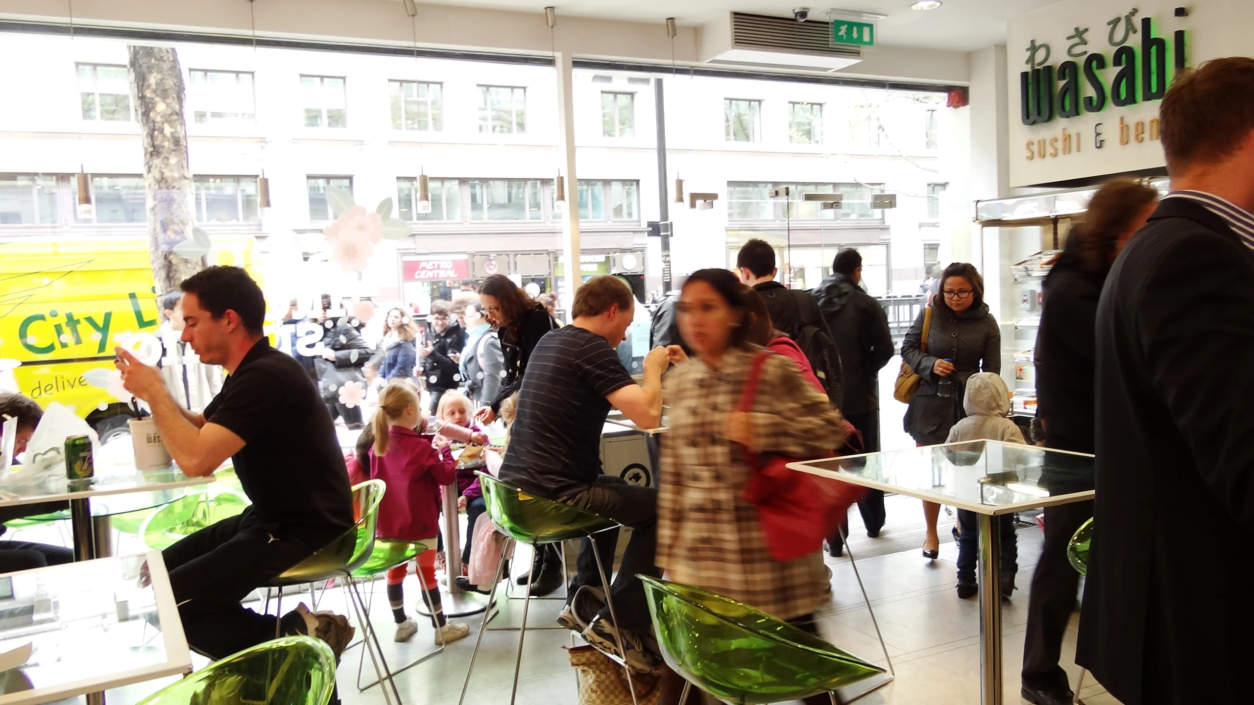 people are standing around in the mall, eating