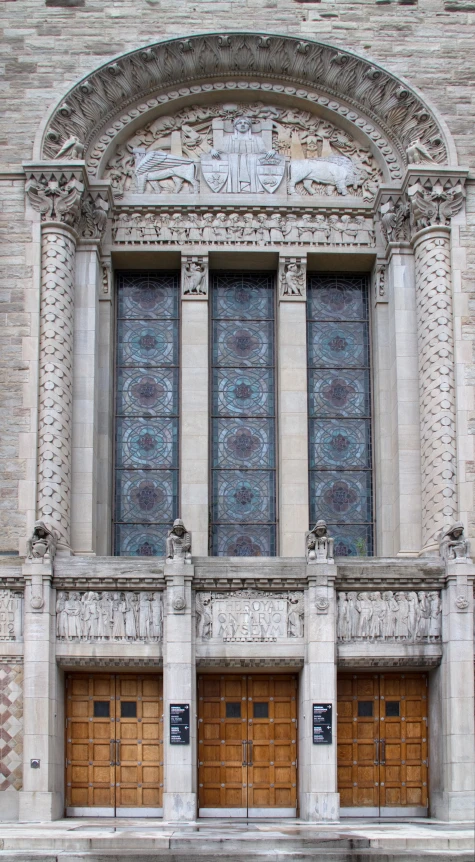 an old looking building with three doors on the outside