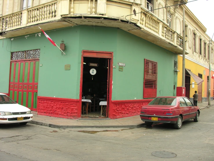 an older and newer model cars are parked on the side of a street