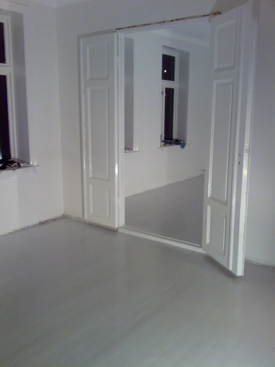 an empty room with a sliding door and window