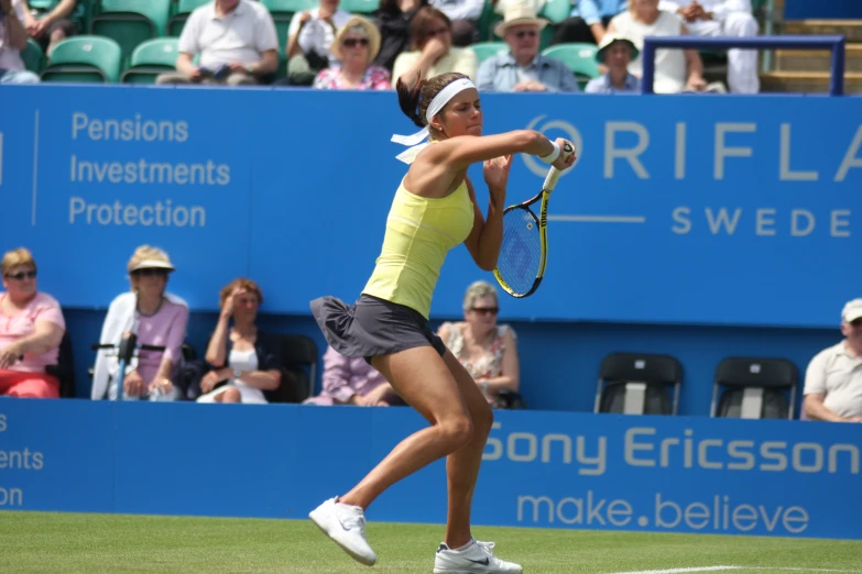 a woman holding a tennis racket on a tennis court