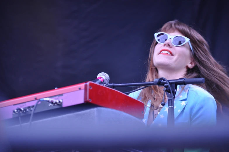 a young woman is standing at a podium speaking