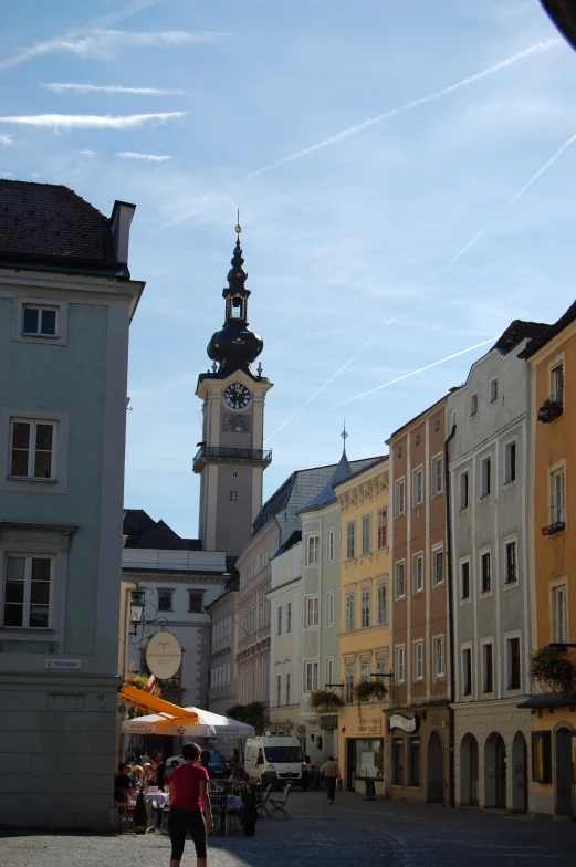 the buildings are built beside each other and are lined with umbrellas