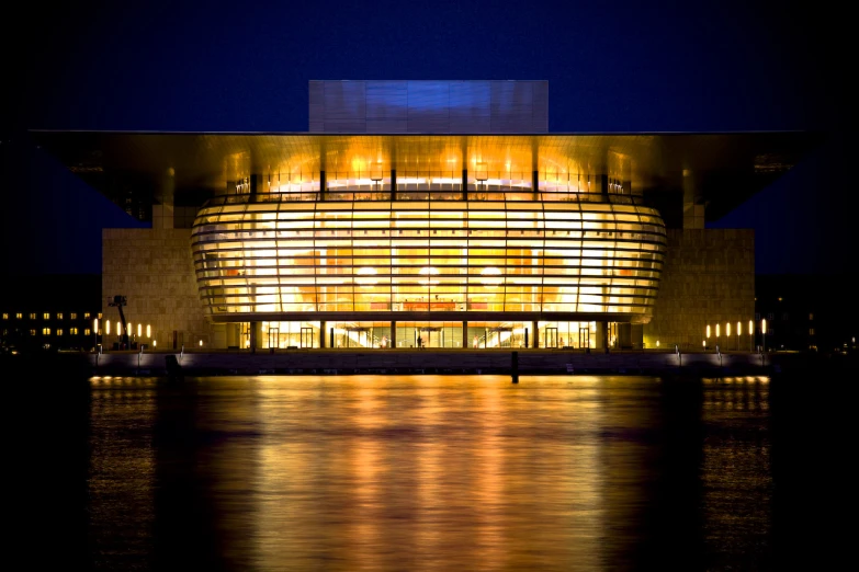 a building that is lit up over some water