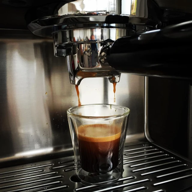 coffee being poured into an espresso machine in a restaurant