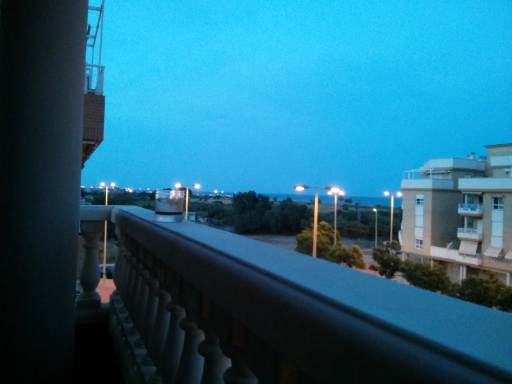 view of a street with lights and a balcony