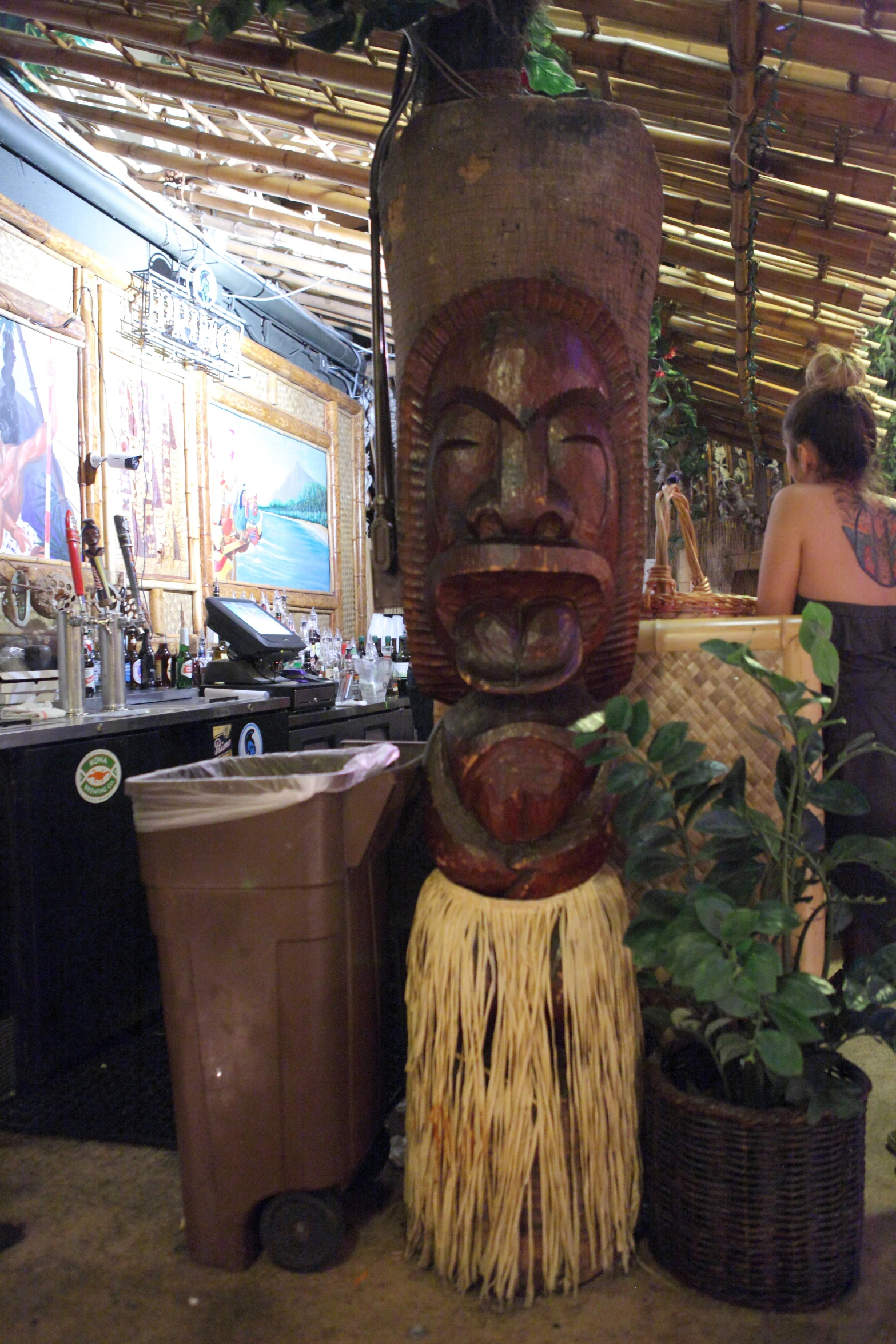 two planters are next to a carved statue