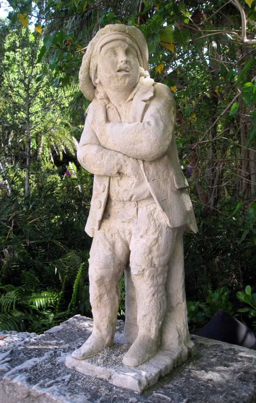 statue on the ground in the park with greenery