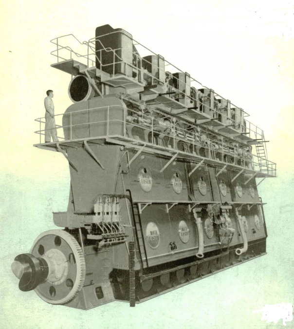 a large machine with several pipes and one man standing next to it