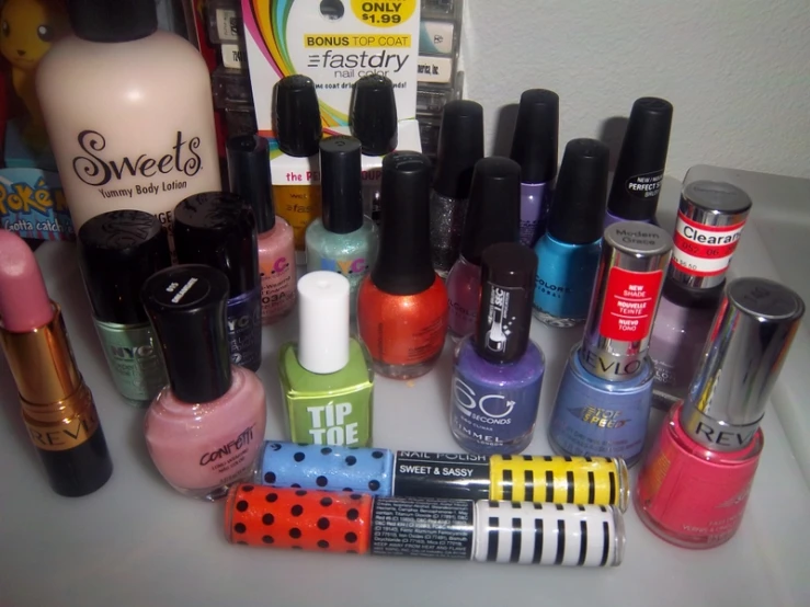 the contents of a table are covered with cosmetics and nail polish