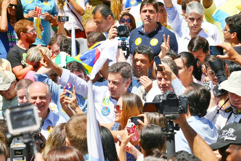 an image of a group of people that are waving and taking pictures