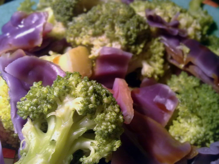 a plate with broccoli and red onions next to the rest of it