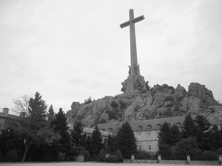 a large stone cross is shown on top of a rock