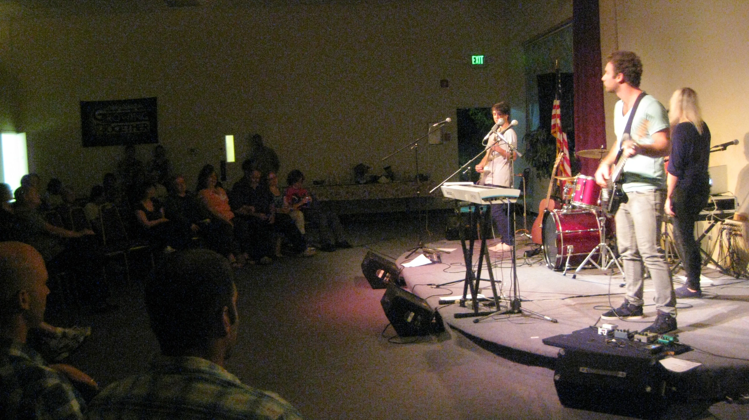 a group of people are singing on a stage