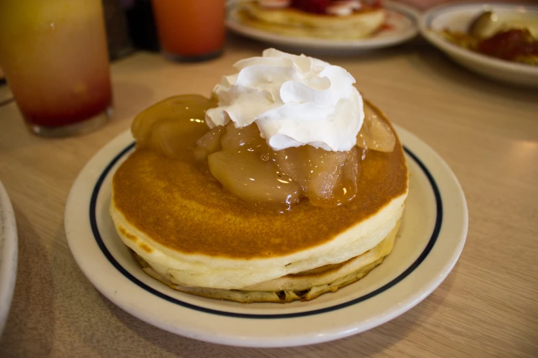 a plate of pancakes covered in toppings and frosting