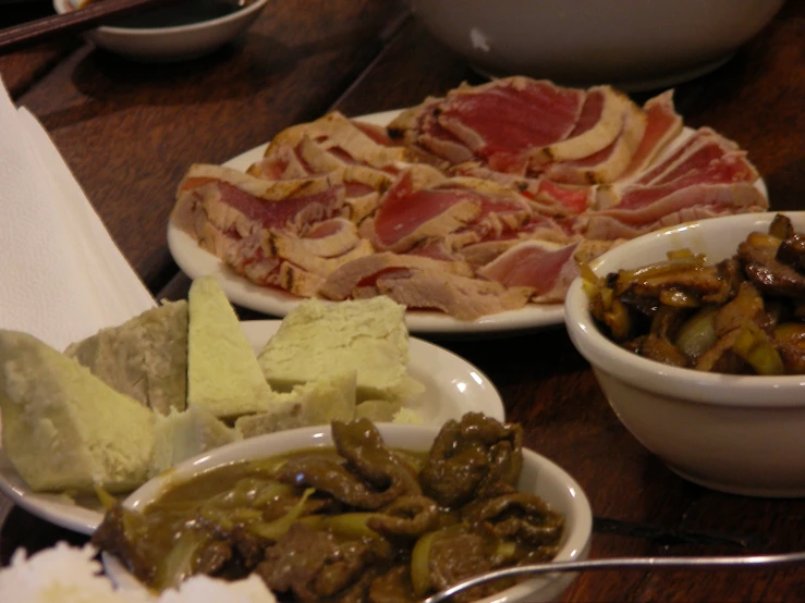 four different foods are arranged in white bowls