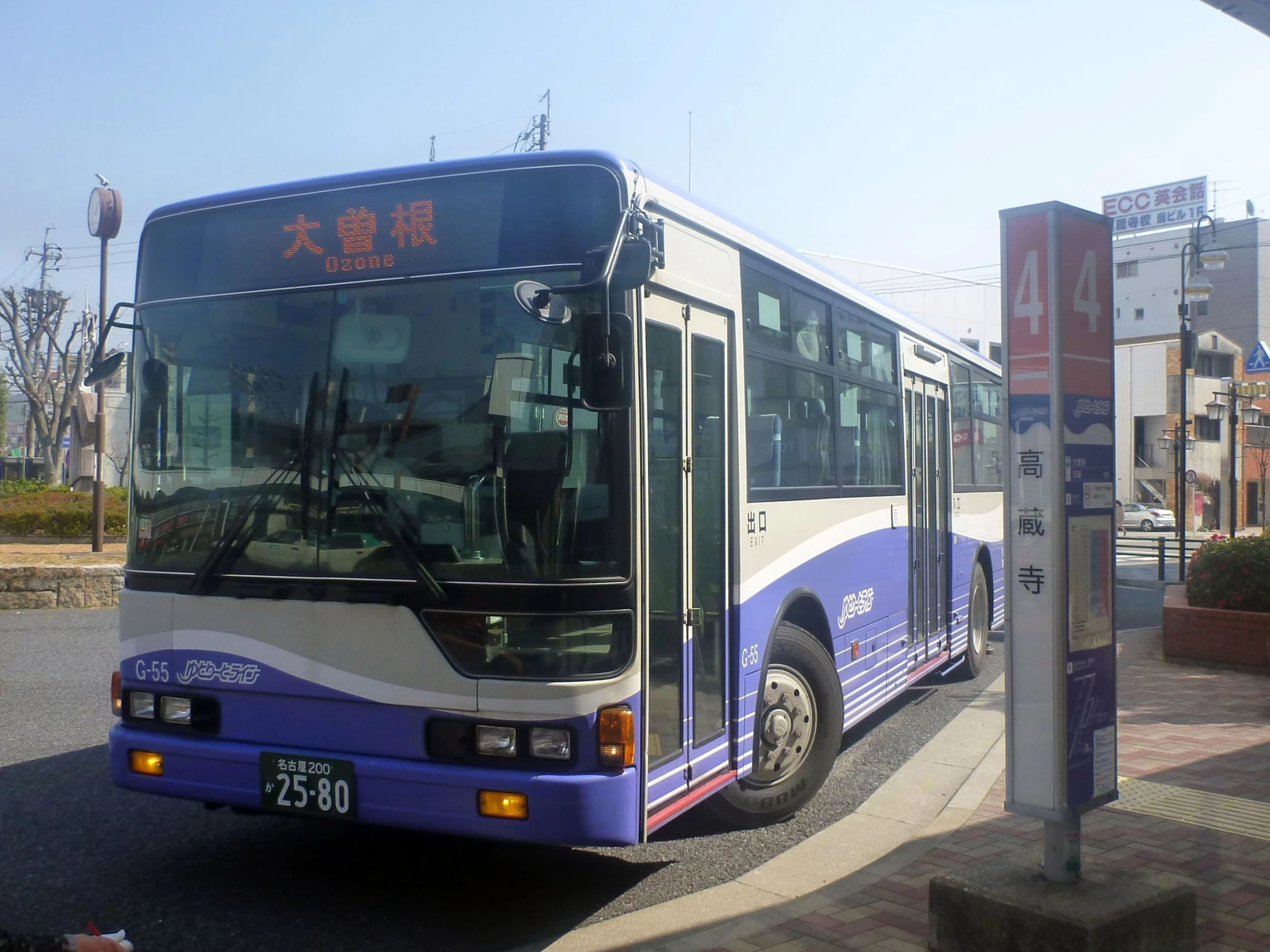 a blue and white bus parked on the side of the street