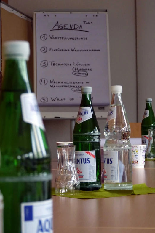 several green soda bottles lined up on a table