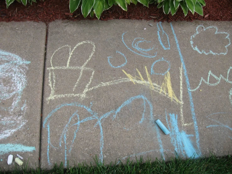 the sidewalk has graffiti and a yellow and blue toothbrush