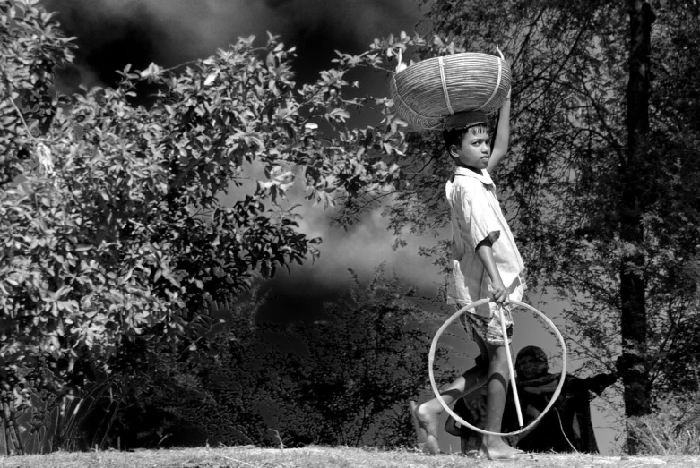 a man carrying a large metal object on his head