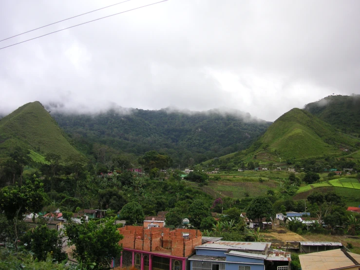 the mountains surrounding town and village are covered in thick clouds