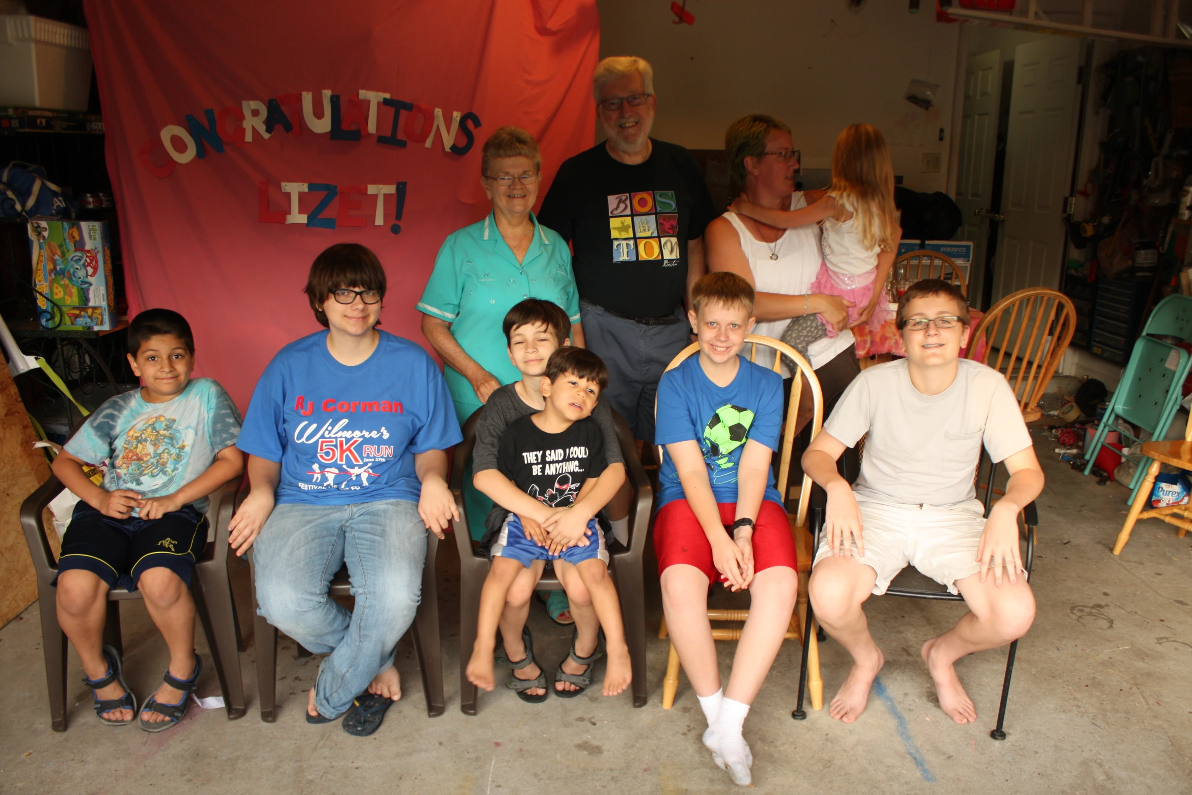 a bunch of people are sitting on a chair together