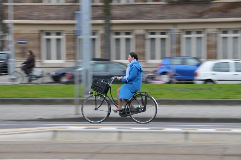 the woman in blue is riding her bike