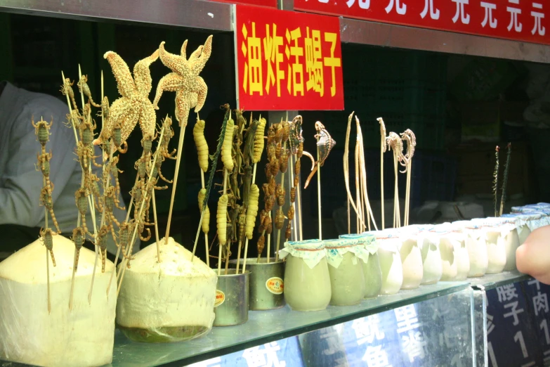 different kind of edible items on sticks at an asian market