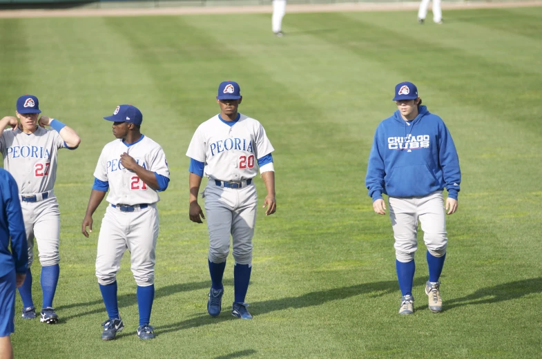 the baseball players are walking across the field