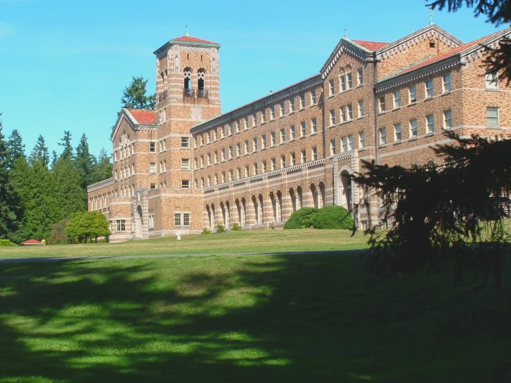 a large building on the side of a hill next to trees