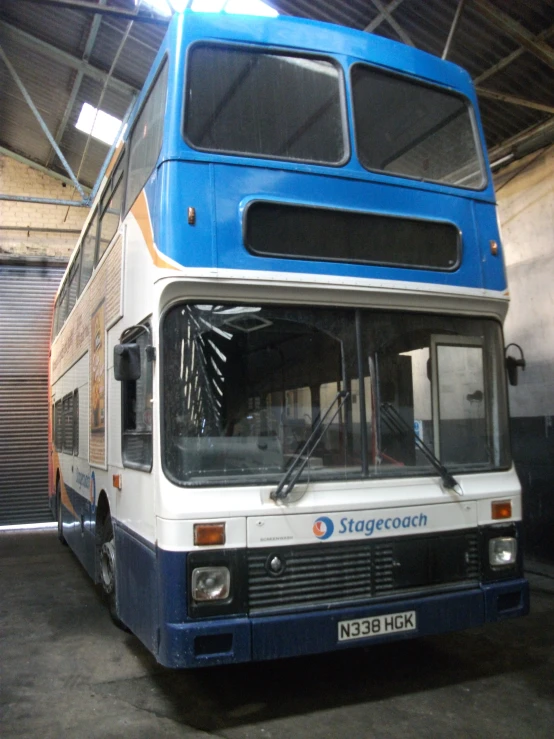 a double decker bus parked inside a garage
