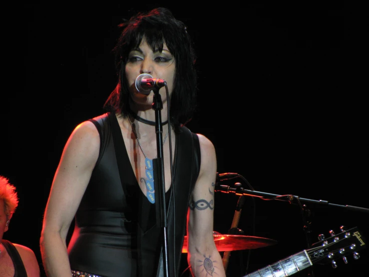 a female musician with her guitar and microphone