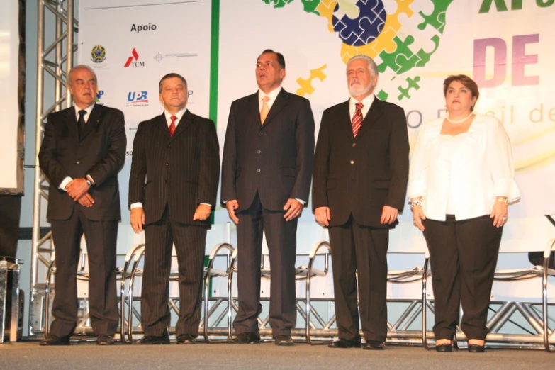 a group of people standing on top of a stage