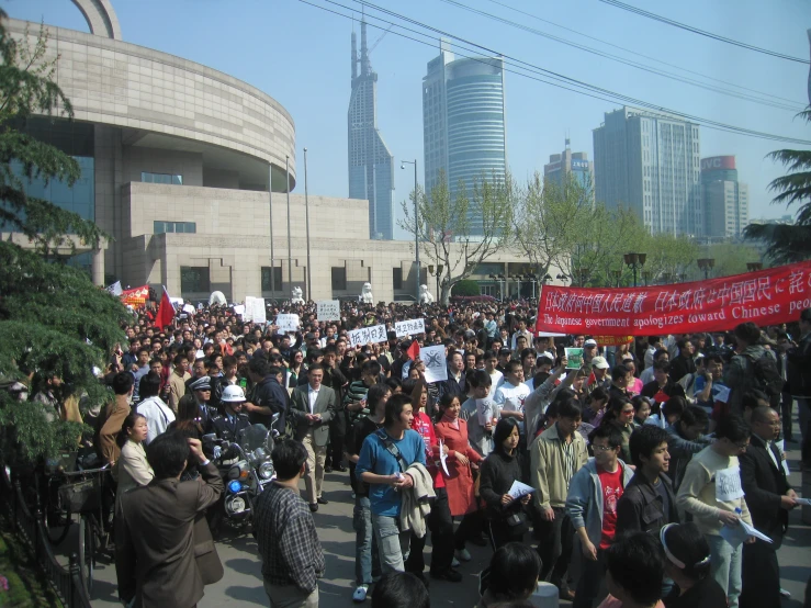 a protest march with people holding placards and large signs