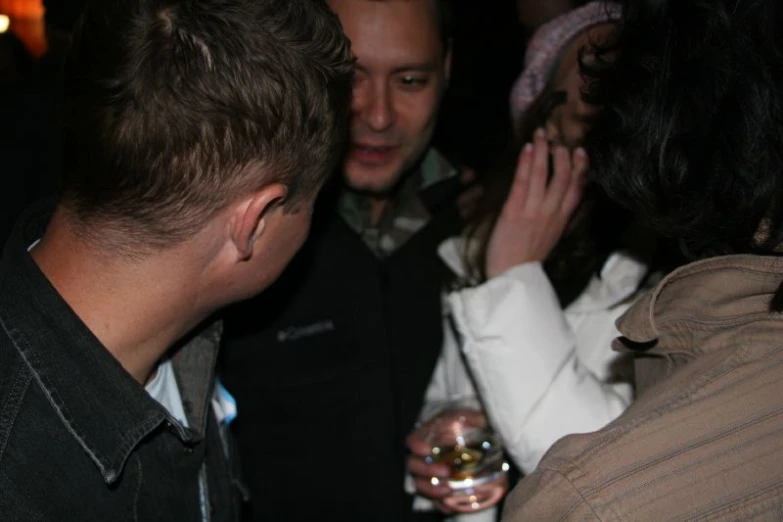 a man with his hand on the glass drinking it