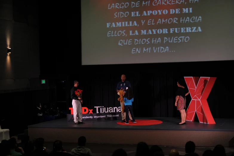 a man and woman standing on a stage