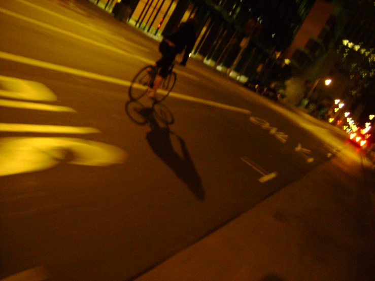 a man riding a bike in a dark city